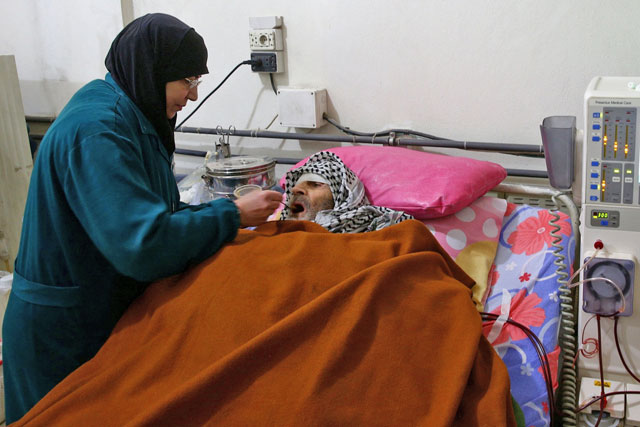 A man is fed while receiving  treatment inside the dialysis centre in the rebel-held town of Douma, in the besieged Eastern Ghouta suburbs of Damascus, Syria, on Wednesday (Reuters photo)