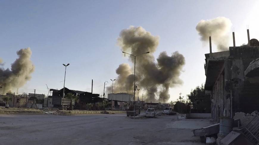 This photo released by the Syrian Civil Defense White Helmets that has been authenticated based on its contents and other AP reporting, shows smoke rising after Syrian government airstrikes hit in the town of Douma, in eastern Ghouta east of Damascus Saturday. | SYRIAN CIVIL DEFENSE WHITE HELMETS / VIA AP