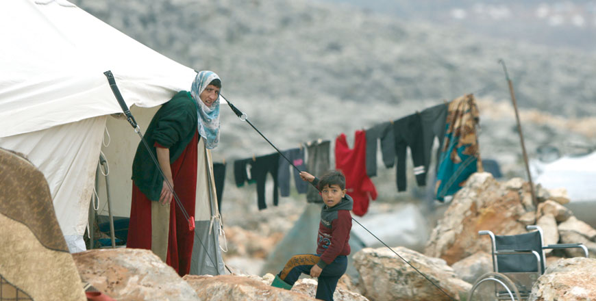 Syrians are pictured at a makeshift camp for displaced people on February 18, north of the city of Idlib, near the Turkish border (AFP photo)