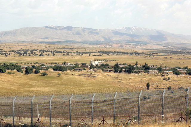 This photo, taken from the Israeli-annexed Golan Heights on Friday, shows the border fence with the south-western Syrian governorate of Quneitra (AFP photo)