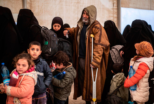 Families wait in line for departure during the release of another group of Syrian families from the Kurdish-run Al-Hol camp which holds suspected relatives of the Daesh terror group fighters, in Hasakeh governorate in northeastern Syria, on Thursday (AFP photo)