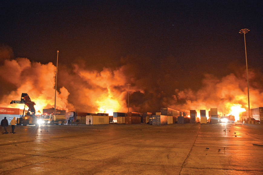 This handout photo released by the official Syrian Arab News Agency (SANA) shows firefighters battling the blaze at Syria's Latakia port after an Israeli air strike early on Tuesday (AFP photo)