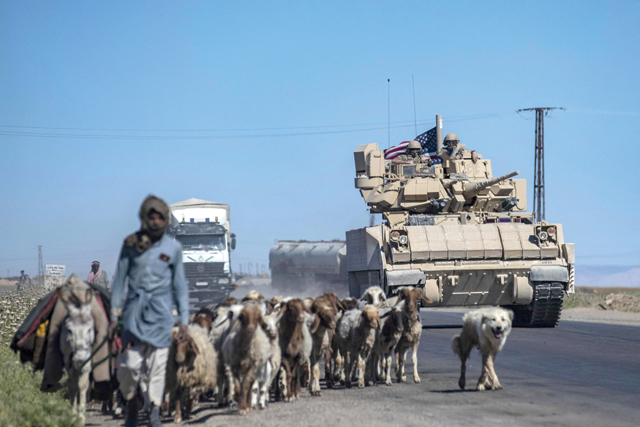 US forces patrol near the countryside of Rumaylan in Syria's north-eastern Hasakeh province near the Turkish border (AFP photo)