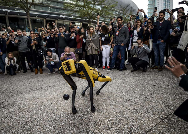 People take photos and videos of Boston Dynamics Robot Dog named ‘Spot’ during a presentation on the last day of the Web Summit in Lisbon on November 7  (AFP photo by Patricia de Melo Moreira)