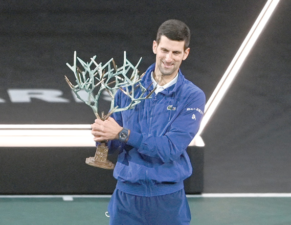 Serbia’s Novak Djokovic celebrates with the trophy after winning the ATP Paris Masters title in Paris on Sunday (AFP photo by Anne-Christine Poujoulat)