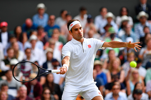 Switzerland’s Roger Federer returns against France’s Lucas Pouille during their men’s singles match at the 2019 Wimbledon Championships in London on Saturday  (AFP photo by Glyn Kirk)