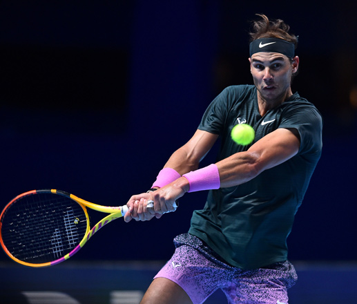 Spain’s Rafael Nadal returns against Austria’s Dominic Thiem in their men’s singles round-robin match at the ATP World Tour Finals tournament in London on Tuesday  (AFP photo by Glyn Kirk)