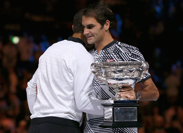 Switzerland’s Roger Federer embraces Spain’s Rafael Nadal after winning his men’s singles final match at the Australian Open in Melbourne on Sunday (Reuters photo by Issei Kato)