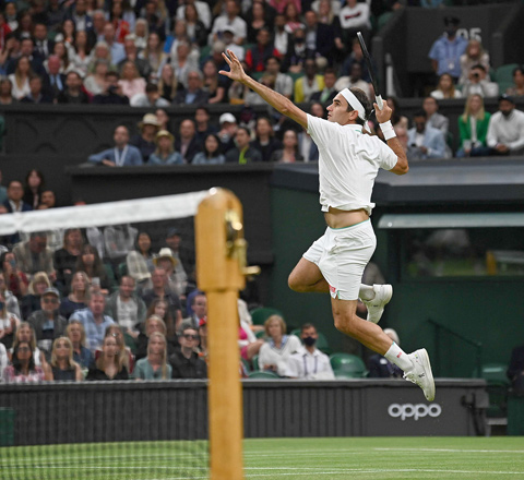 Switzerland’s Roger Federer jumps to return against Italy’s Lorenzo Sonego in their men’s singles fourth round match at the 2021 Wimbledon Championships in London on Monday (AFP photo by Glyn Kirk)