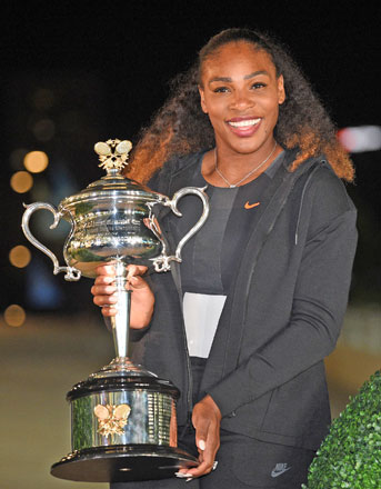 Serena Williams of the US poses with her trophy after beating her sister Venus in the women’s singles final of the Australian Open in Melbourne on Saturday  (AFP photo by Saeed Khan)
