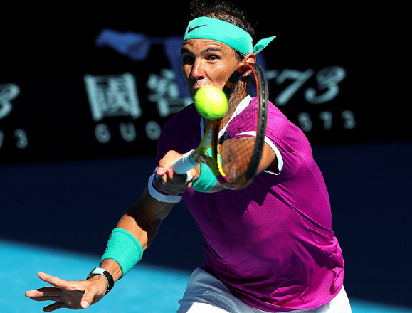 Spain’s Rafael Nadal hits a return against Canada’s Denis Shapovalov during their men’s singles quarter-final match at the Australian Open in Melbourne on Tuesday (AFP photo by Aaron Francis)