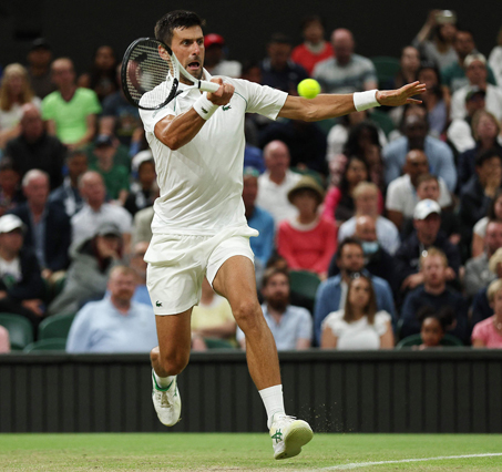 Serbia’s Novak Djokovic returns the ball to Netherlands’ Tim van Rijthoven during their round of 16 men’s singles match at the 2022 Wimbledon Championships in London on Sunday (AFP photo by Adrian Dennis)