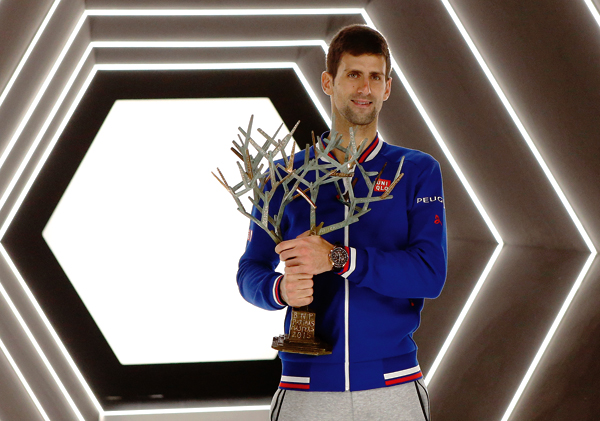 Serbia’s Novak Djokovic poses with the trophy after winning Britain’s Andy Murrray during their final match of the BNP Masters tennis tournament in Paris, on Sunday (AP photo by Francois Mori)