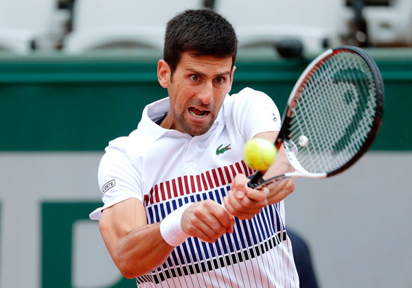 Serbia’s Novak Djokovic returns the ball to Austria’s Dominic Thiem during their tennis match at the Roland Garros 2017 French Open in Paris on Wednesday  (AFP photo by Thomas Samson)