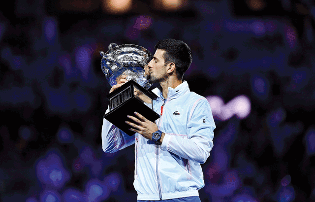 Serbia’s Novak Djokovic kisses the trophy after beating Greece’s Stefanos Tsitsipas in the men’s singles final match at the Australian Open in Melbourne on Sunday (AFP photo by Manan Vatsyayana)