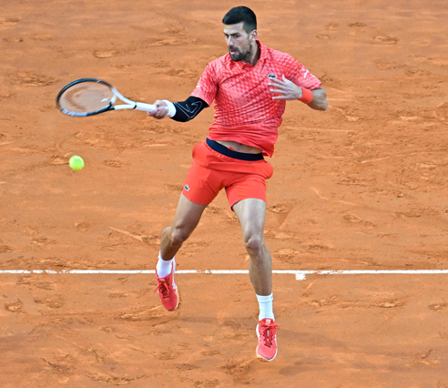 Serbia’s Novak Djokovic returns to Argentina’s Tomas Etcheverry at the Men’s ATP Rome Open tournament in Rome on Friday (AFP photo by Filippo Monteforte)