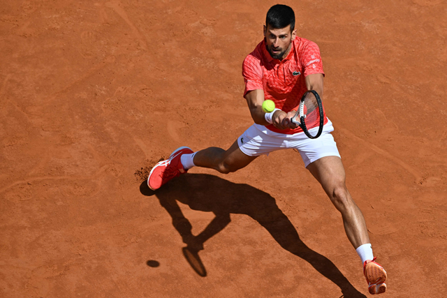 Serbia’s Novak Djokovic returns to Bulgaria’s Grigor Dimitrov during their third round match at the Men’s ATP Rome Open tournament in Rome on Sunday (AFP photo by Tiziana Fabi)