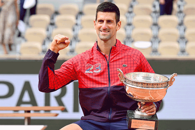 Serbia’s Novak Djokovic holds the French Open trophy after beating Norway’s Casper Ruud in their men’s singles final match in Paris on Sunday  (AFP photo by Emmanuel Dunand)