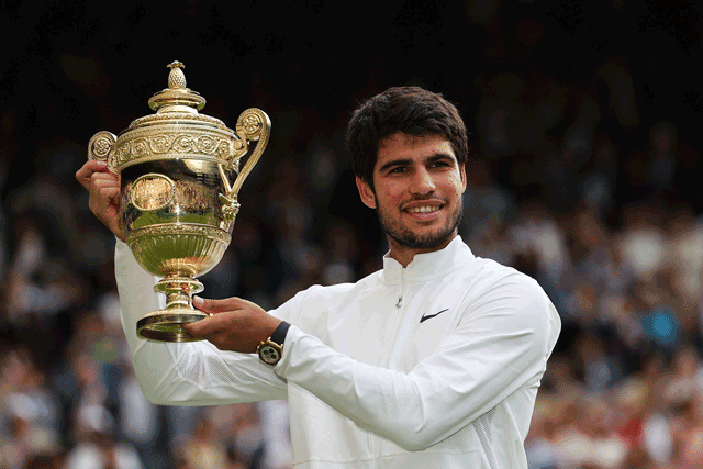 Spain’s Carlos Alcaraz holds the winner’s trophy after beating Serbia’s Novak Djokovic at the men’s singles final match of the 2023 Wimbledon Championships in London on Sunday (AFP photo by Adrian Dennis)