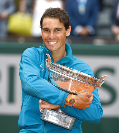 Rafael Nadal of Spain holds the championship trophy after winning the French Open finals match against Dominic Thiem at the Roland Garros Stadium in Paris on Sunday  (Anadolu Agency photo by Mustafa Yalcın)