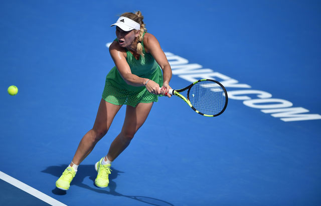 Caroline Wozniacki of Denmark hits a return to Monica Puig of Puerto Rico in their women’s first round match at the Sydney International tournament in Sydney on Monday  (AFP photo by Peter Parks)