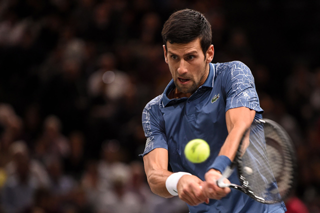 Serbia’s Novak Djokovic returns the ball to Portugal’s Joao Sousa during their men’s singles match at the Paris Masters in Paris, on Tuesday  (AFP photo by Anne-Christine Poujoulat)