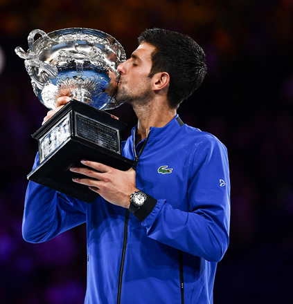 Serbia’s Novak Djokovic celebrates with the championship trophy of the Australian Open in Melbourne on Sunday  (AFP photo by Saeed Khan)