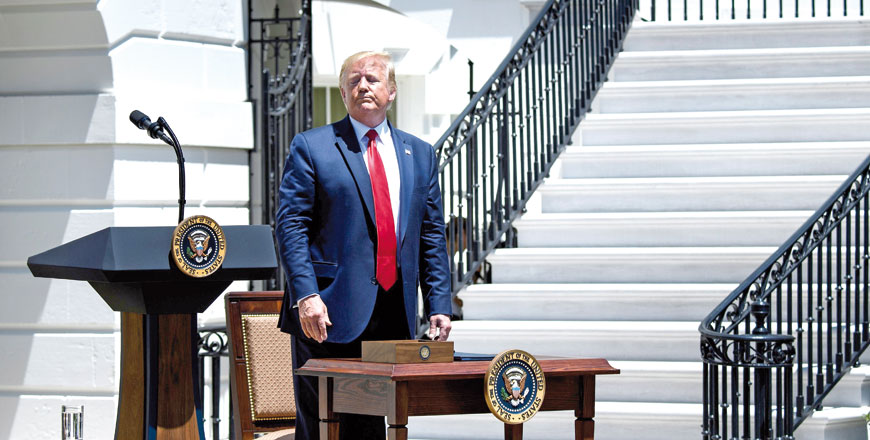 US President Donald Trump waits to sign an executive order during the 3rd Annual Made in America Product Showcase on the South Lawn at the White House in Washington, DC, on Monday (AFP photo)