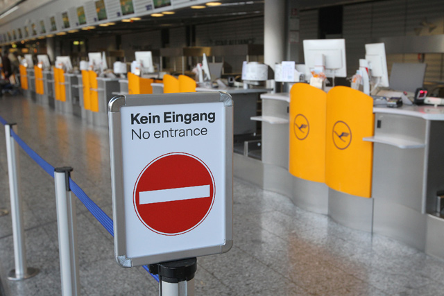 Empty counters of German airline Lufthansa are seen at the airport in Frankfurt am Main, western Germany, on Thursday (AFP photo)