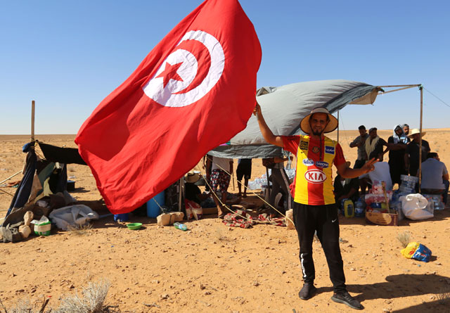 Protesters stage a sit-in outside the oil and gas plant in El Kamour, in Tunisia's southern state of Tatatouine, demanding for a share of the resources and employment in the sector on Thursday (AFP photo)