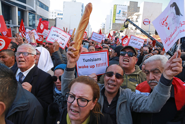 Tunisian opposition supporters take part in a rally against President Kais Saied’s power grab and the economic crisis in the North African country, in the capital of Tunis, on Sunday (AFP photo)