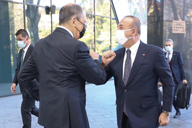 A handout photograph taken and released on Tuesday by the Russian Foreign Ministry shows Russian Foreign Minister Sergei Lavrov (left) welcoming his Turkish counterpart Mevlut Cavusoglu as they touch their arms ahead of their meting in Sochi (AFP photo)
