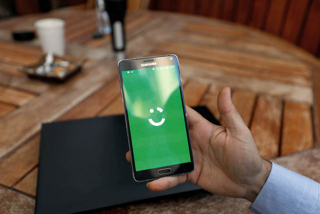 An employee shows the logo of ride-hailing company Careem on his mobile in his office in the West Bank city of Ramallah on Monday (Reuters photo)