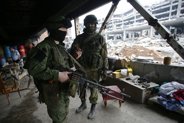An armed pro-Russian separatist of the self-proclaimed Donetsk People’s Republic walks in front of the destroyed Donetsk International Airport in Donetsk, on Wednesday (AFP photo)