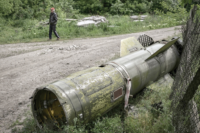 A man walks near the remains of a missile in the city of Lysychansk, in the eastern region of Donbas, on Thursday (AFP photo)