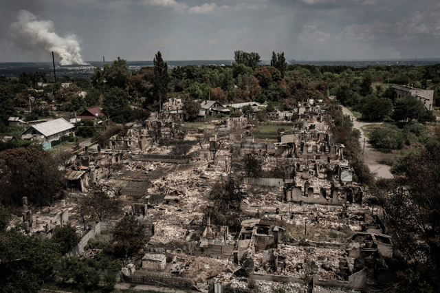 An aerial view shows destroyed houses after strike in the town of Pryvillya at the eastern Ukrainian region of Donbas on Tuesday, amid Russian invasion of Ukraine (AFP photo)
