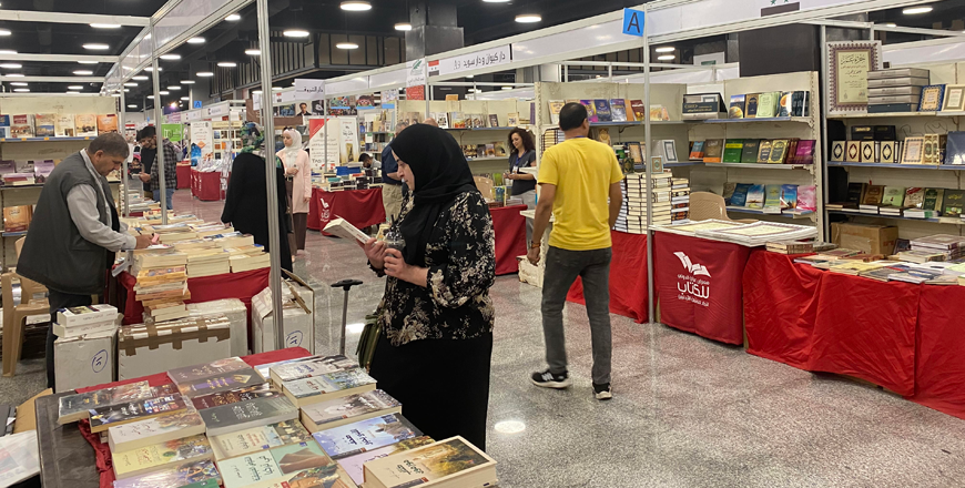 A fair visitor is seen looking at books displayed during the 21st edition of the Amman International Book Fair on Saturday (Photo by Mays Ibrahim Mustafa)