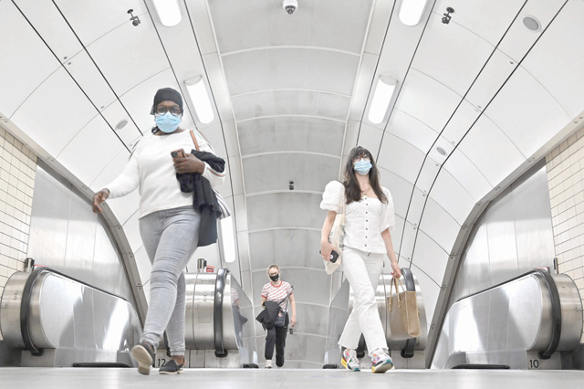 Passengers emerge from the London Underground in central London on Wednesday (AFP photo)