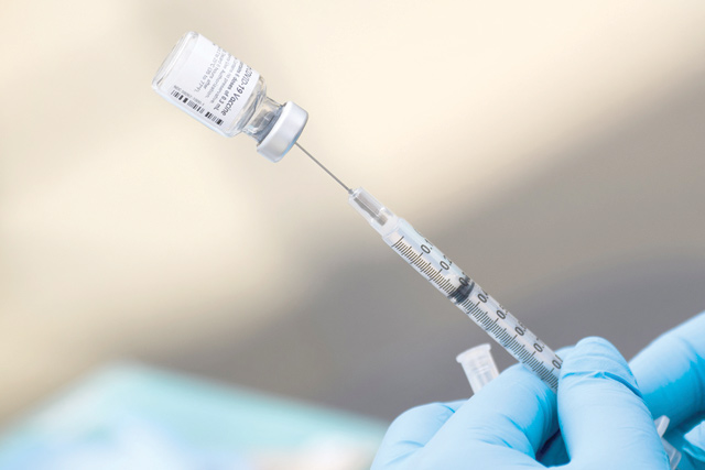 In this file photo a syringe is filled with a first dose of the Pfizer COVID-19 vaccine at a mobile vaccination clinic at the Weingart East Los Angeles YMCA in Los Angeles, California, on August 7 (AFP photo)