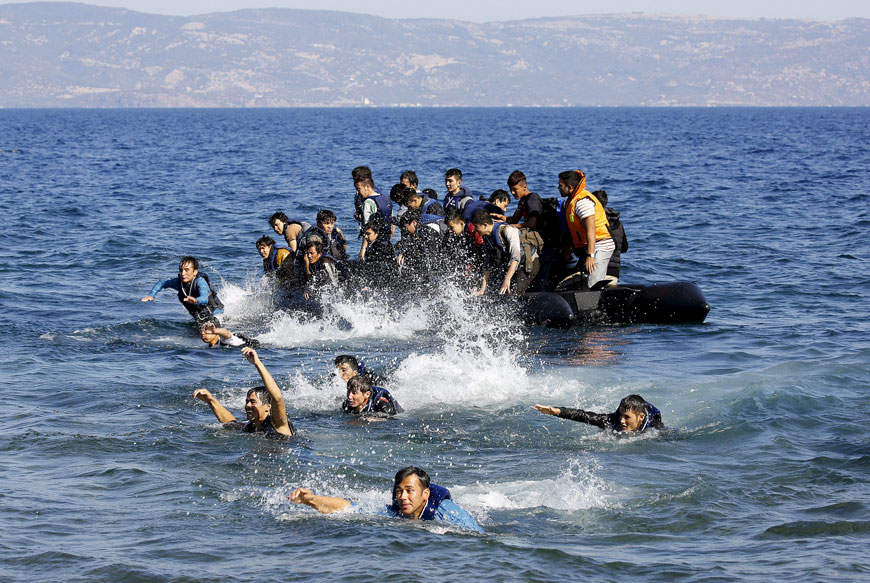 Afghan refugees struggle to swim ashore after their dinghy with a broken engine drifted out of control off the Greek island of Lesbos while crossing a part of the Aegean Sea from the Turkish coast Saturday (Reuters photo)