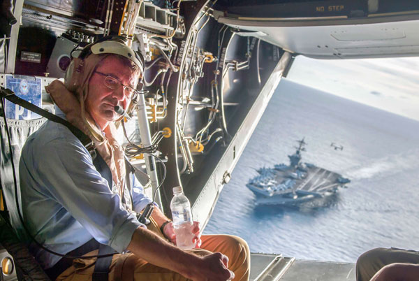 The USS Theodore Roosevelt can be seen in the background as US Secretary of Defence Ash Carter flies in a V-22 Osprey after visiting the aircraft carrier in the South China Sea, in this handout photograph taken and released on Thursday (Reuters photo)