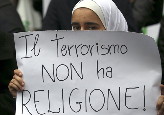 A girl holds a placard during a demonstration called ‘Not in my name’ of Italian Muslims against terrorism in downtown Rome, Italy, on Saturday (Reuters photo)
