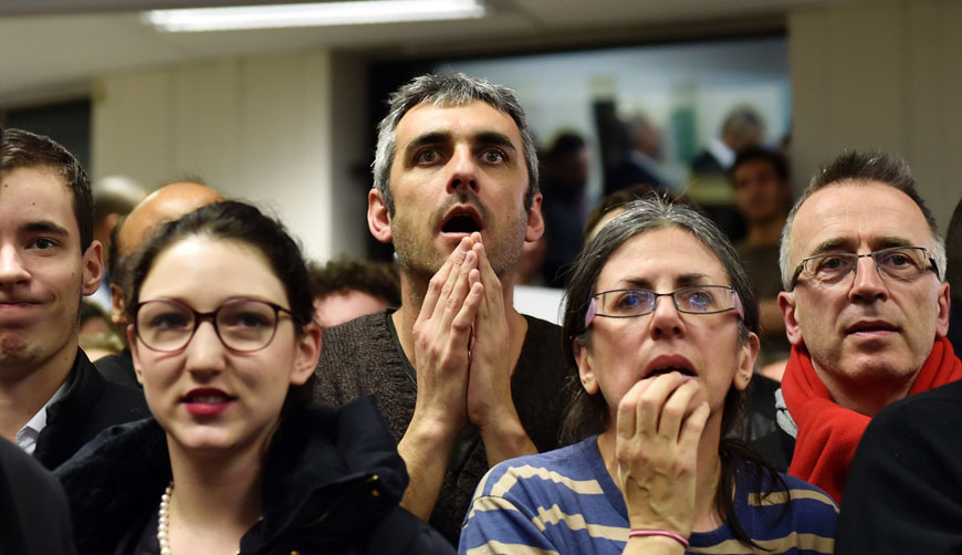 French Socialist Party (PS) supporters react after the announcement of the first results of the second round of the French regional elections at the headquarters of the PS candidate for the Ile-de-France region in Paris, on Sunday (AFP photo)