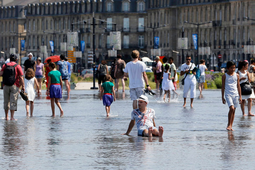 People cool off from the heat at the Miroir d’Eau (Mirror of Water), a public art piece on the quay of the Garonne River, during a warm summer day in Bordeaux, southwestern France, on Tuesday (Reuters photo)