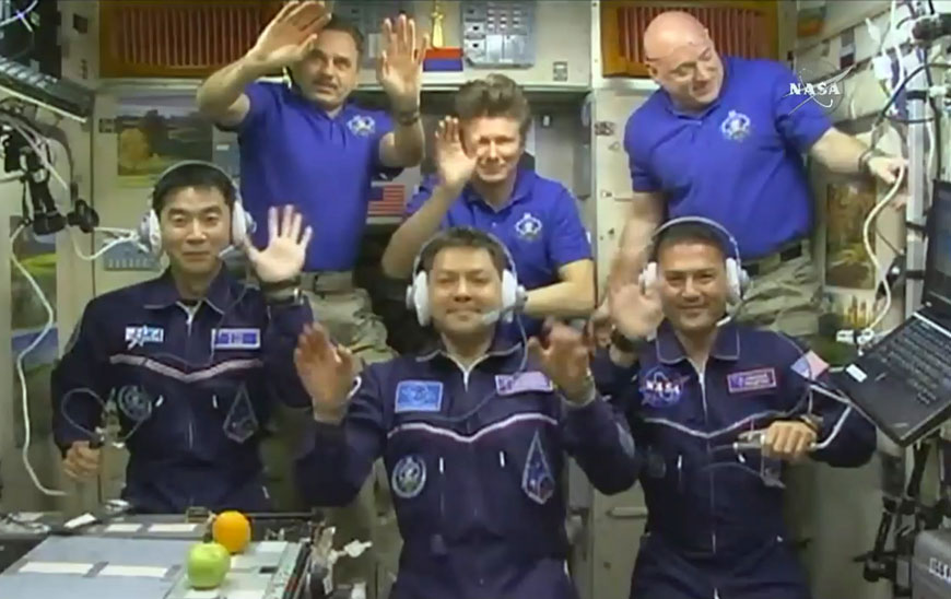 In this image taken from video from NASA, astronauts (front row from left) Kimiya Yui, of Japan, Oleg Kononenko, of Russia and Kjell Lindgren, of the United States, wave after they boarded the International Space Station early on Thursday. Joining the new crew are (rear row from left) astronauts Mikhail Kornienko and Gennady Padalka, from Russia, and Scott Kelly of the US (AP photo)