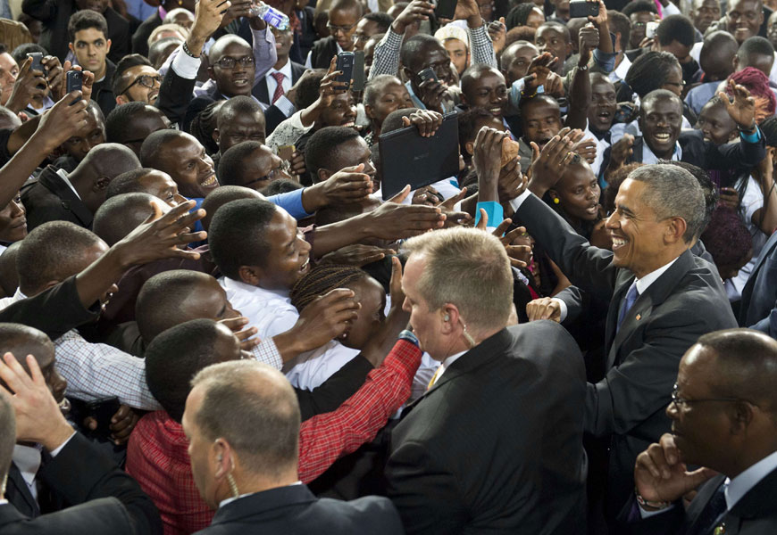 US President Barack Obama (right) greets the crowd after speaking at Safaricom Indoor Arena in Nairobi on Sunday (AFP photo)