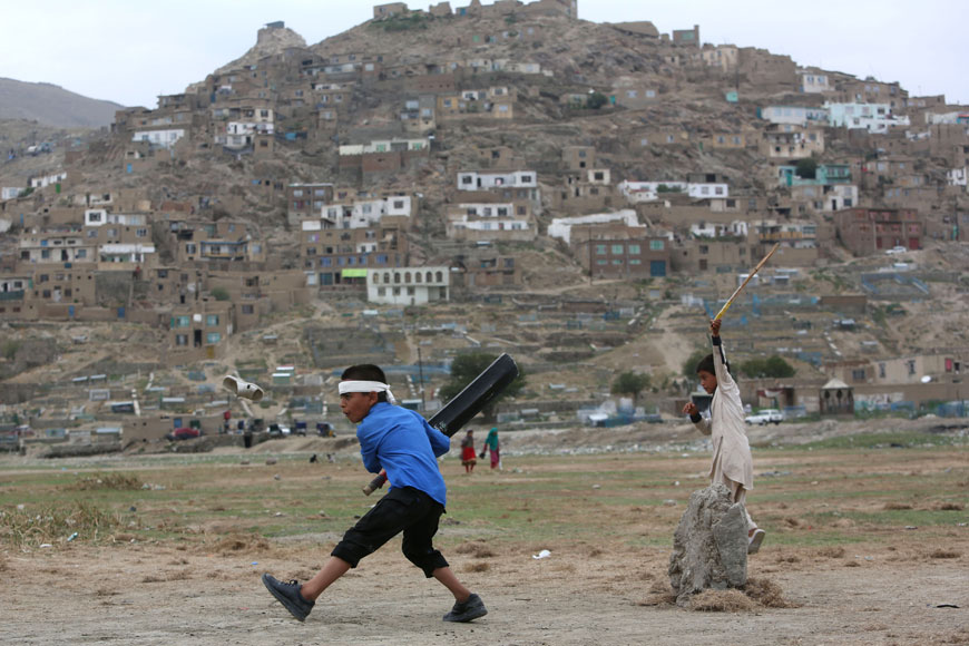 Afghan children play cricket on the outskirts of Kabul, Afghanistan, on Monday (AP photo)