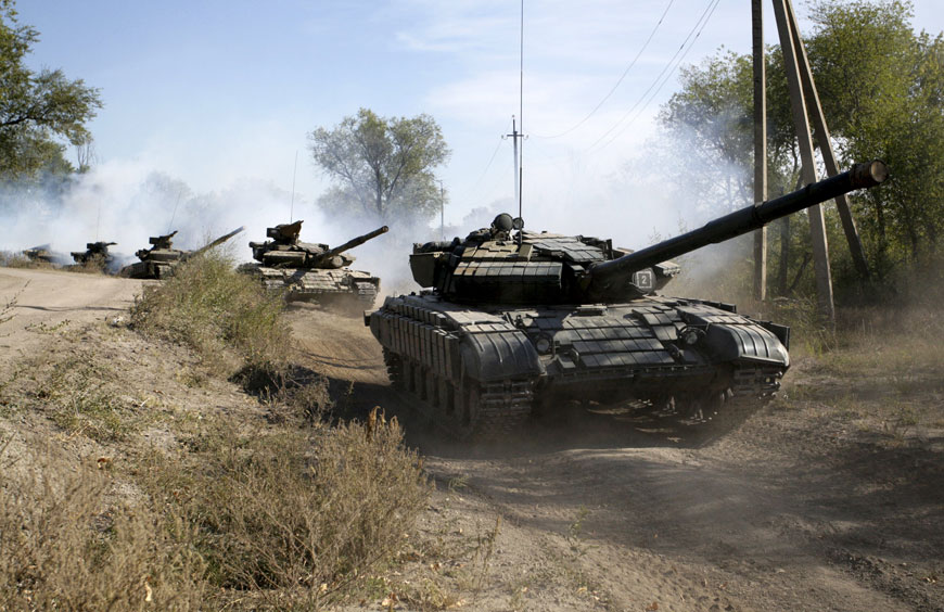 Members of the self-proclaimed Luhansk People’s Republic ride tanks as they withdraw them further from the front line outside Luhansk, Ukraine, on Saturday (Reuters photo)