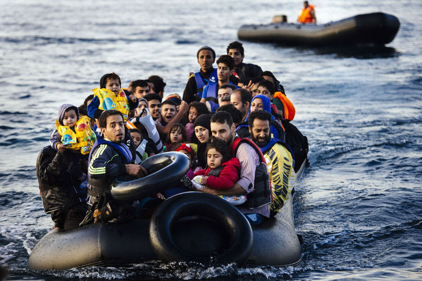 Migrants and refugees arrive on a dinghy on the Greek island of Lesbos, after crossing the Aegean Sea from Turkey, on Wednesday (AFP photo)