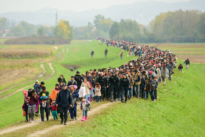 Migrants and refugees walk towards a refugee centre after crossing the Croatian-Slovenian border near Brezice on Friday (AFP photo)